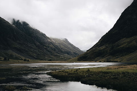 mountain and body of water, landscape photography of mountain under cloudy sky HD wallpaper