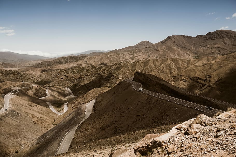 aerial photography of brown mountains, aerial photography of road on mountain range during daytime HD wallpaper