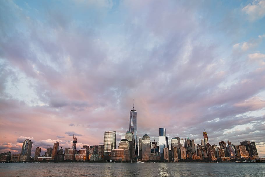 assorted buildings near body of water under cloudy sky, skyline photography of city buildings under blue sky at daytime HD wallpaper