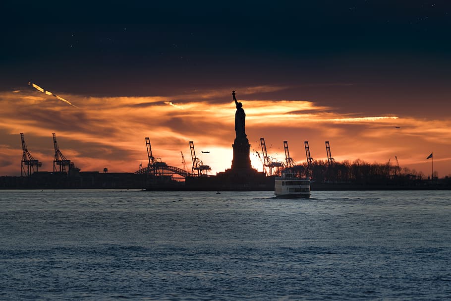 silhouette of Statue of Liberty near body of water, silhouette of Statue of Liberty during sunset