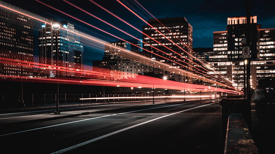 long exposure photography of road and cars, time lapse photography of lights passing by the road on city during nighttime