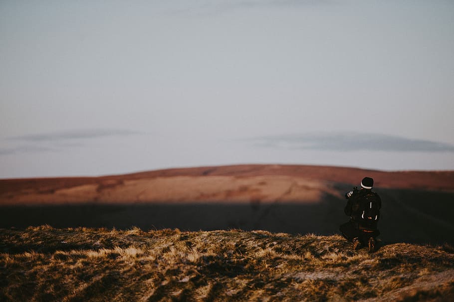 man taking photo of brown open field, shallow focus photography of person using camera HD wallpaper