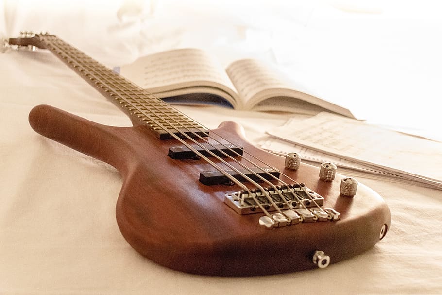 brown 5-strings bass guitar beside book, under, music, warwick