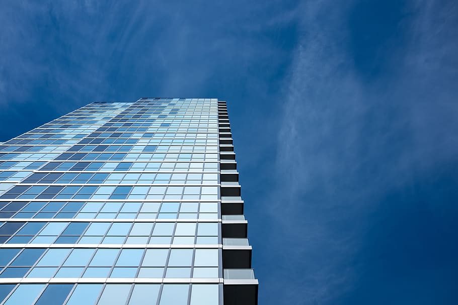 ground shot of skyscraper during daytime, low angle photography of glass building during daytime