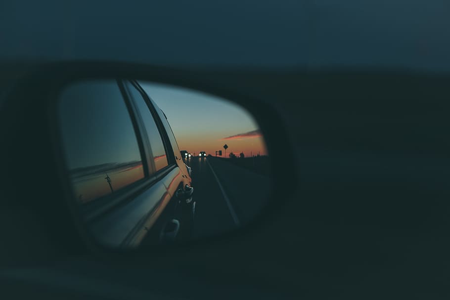 shallow focus photo of car side mirror, tilt shift lens photography of car side mirror during nighttime