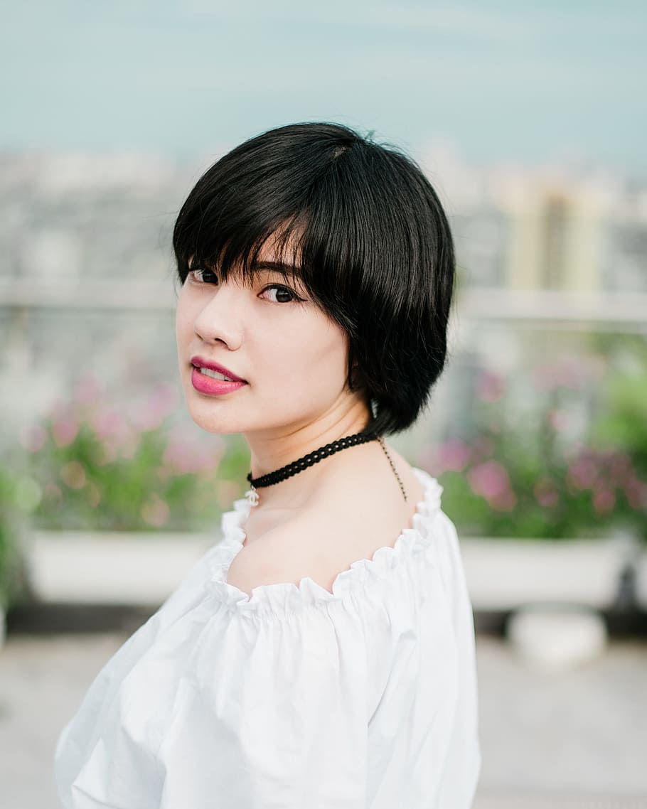 selective focus photo of woman wearing white top and black choker necklace, black haired woman wearing white top