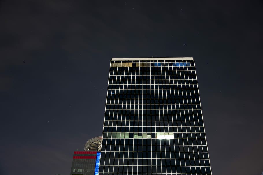 low-angle photo of high-rise building during night time, curtain wall building at night time HD wallpaper