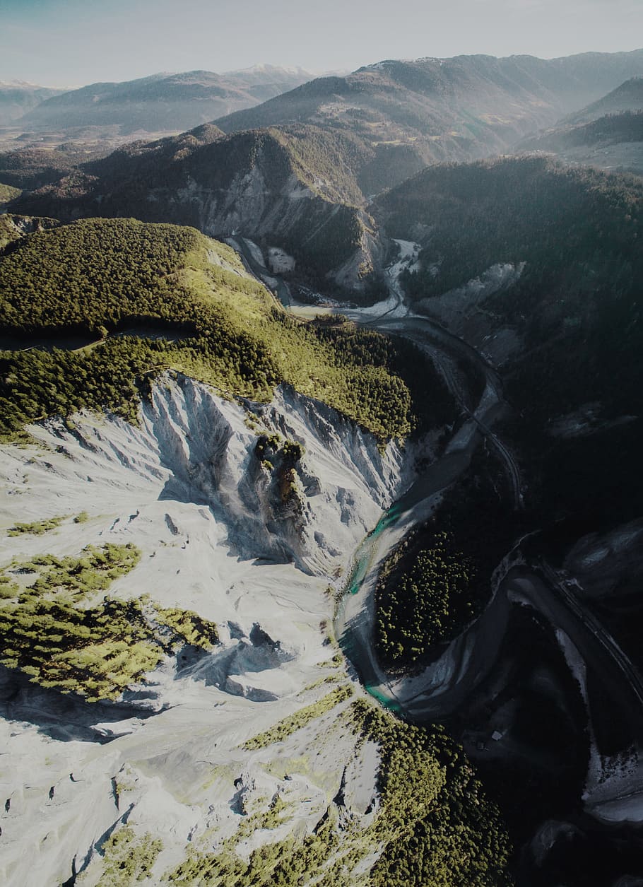 aerial photography of rock mountain and river during daytime, aerial view of mountain hill HD wallpaper