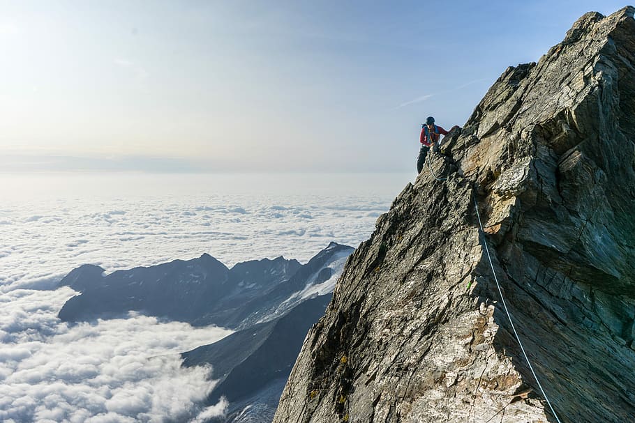 man climbing on gray mountain, birds eye view of a person on mountain cliff HD wallpaper