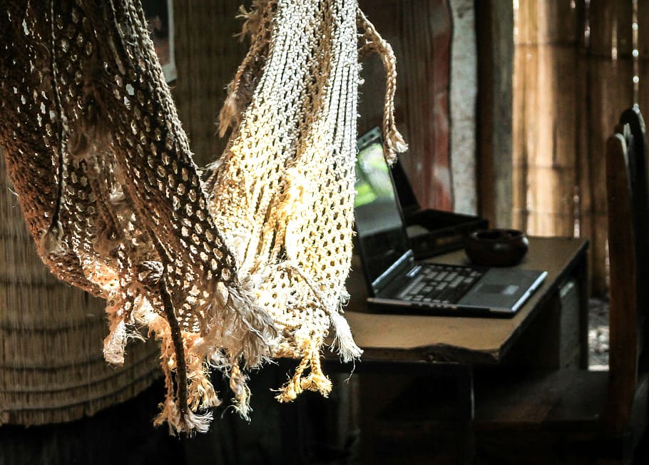 brown broken hammock near black laptop computer on brown wooden table HD wallpaper