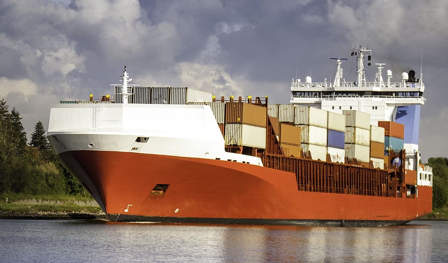 brown and white cargo ship docked beside grass field, freighter HD wallpaper