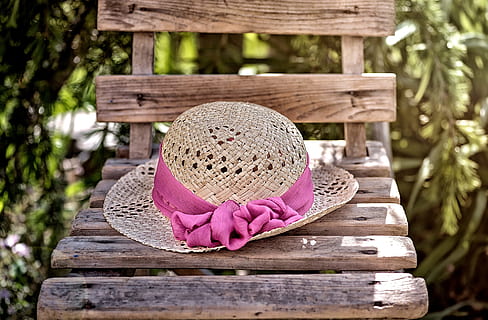 brown wicker hat with pink ribbon on top of brown wooden chair HD wallpaper
