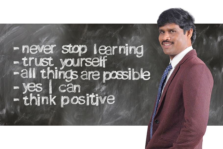 man wearing maroon suit jacket beside inspirational quote, successful