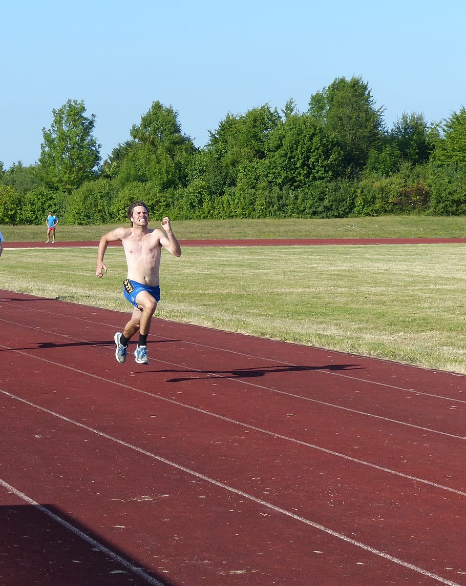 man running on track field during daytime, athletics, sport, race