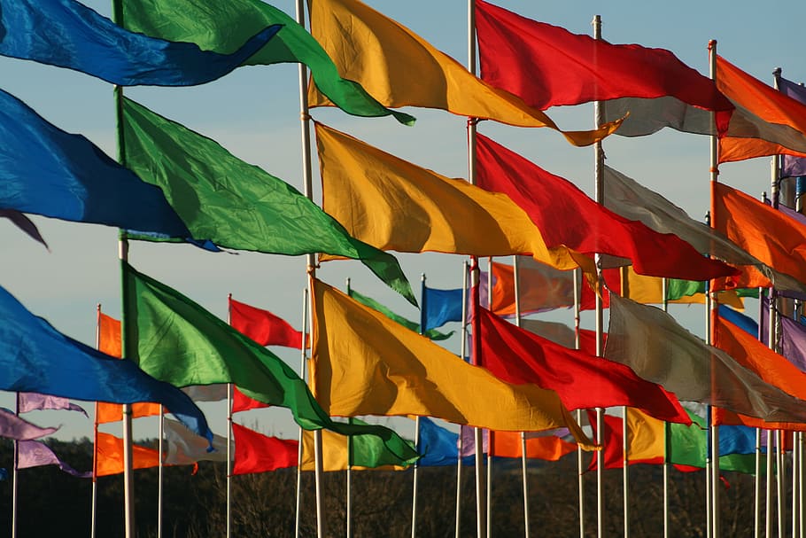 assorted-colored flags waving in the wind, multicolored flag lot HD wallpaper