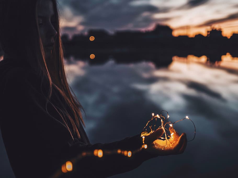 selective focus photography of woman holding string light, dark HD wallpaper