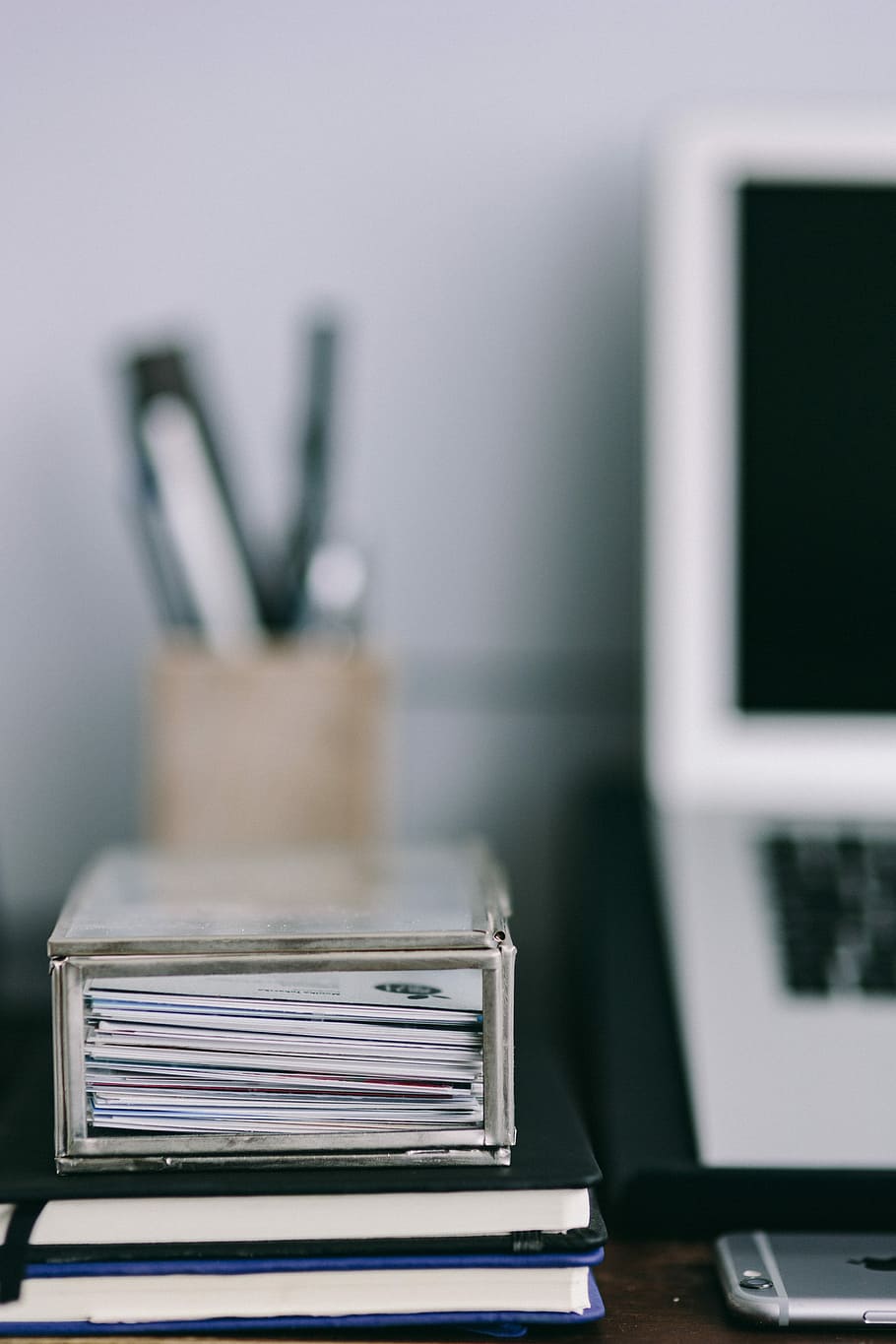 Elegant workspace with Macbook, iPhone, business cards and notebooks HD wallpaper
