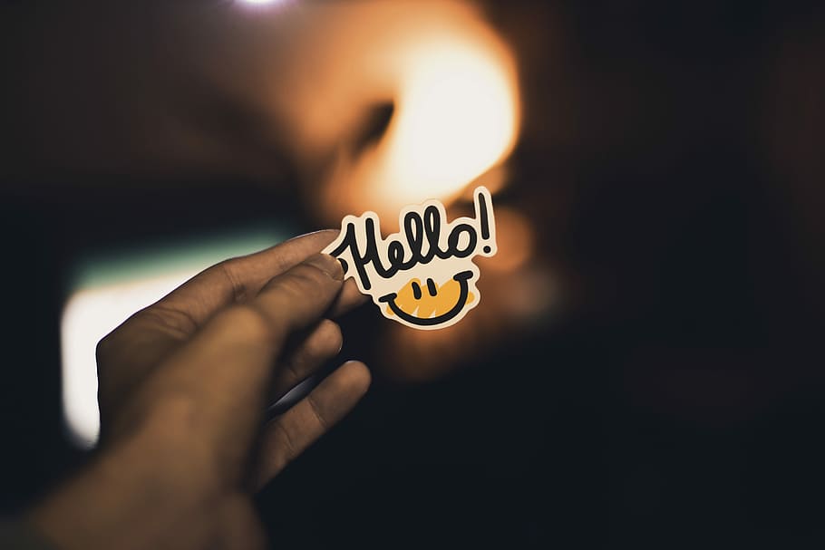 person holding Hello! sticker, person holding hello signage, hand HD wallpaper