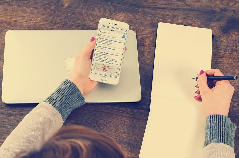 woman holding silver iPhone 6 and black ballpoint pen, office HD wallpaper
