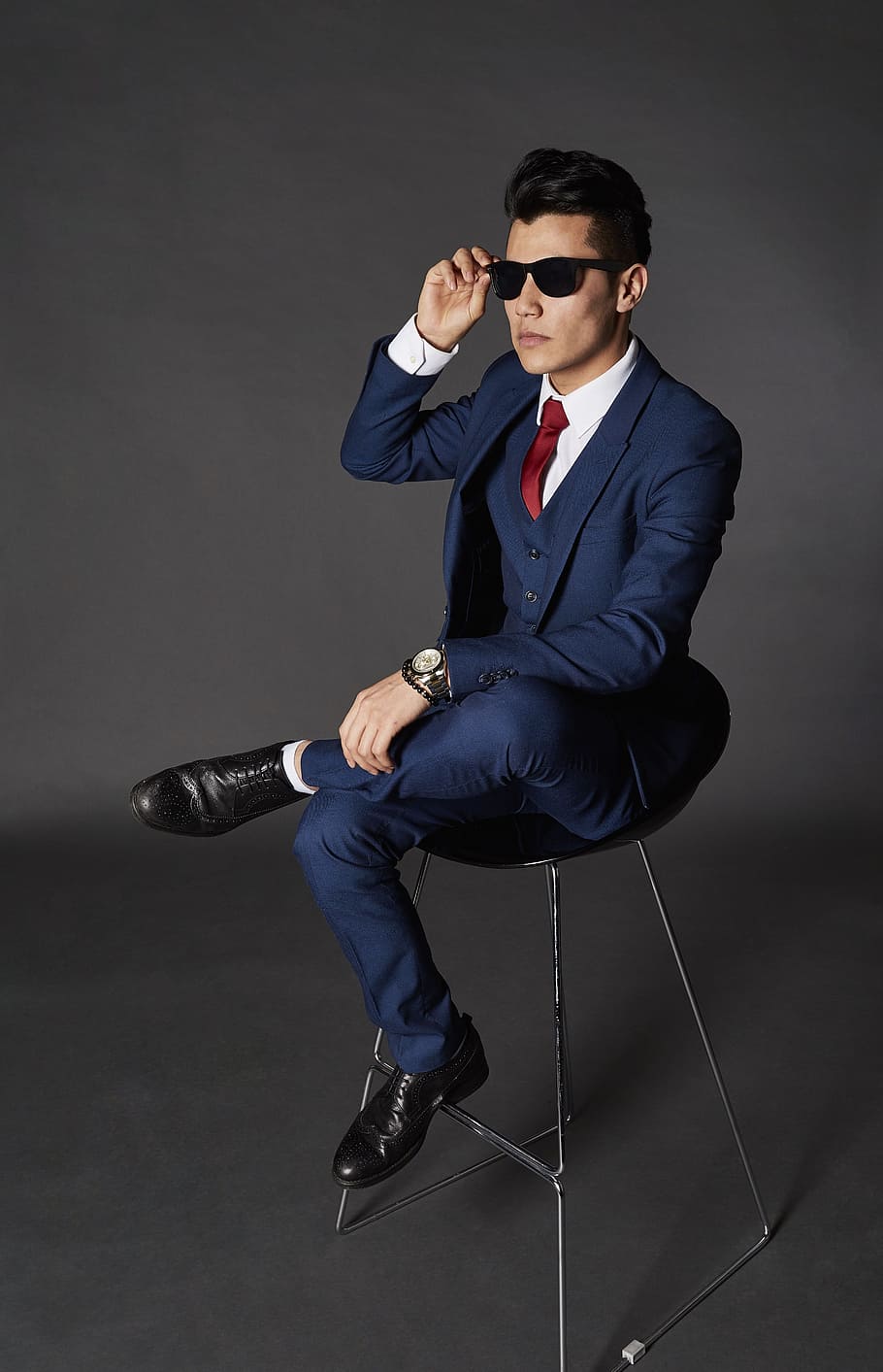 man sitting on chair while holding sunglasses, model, businessman