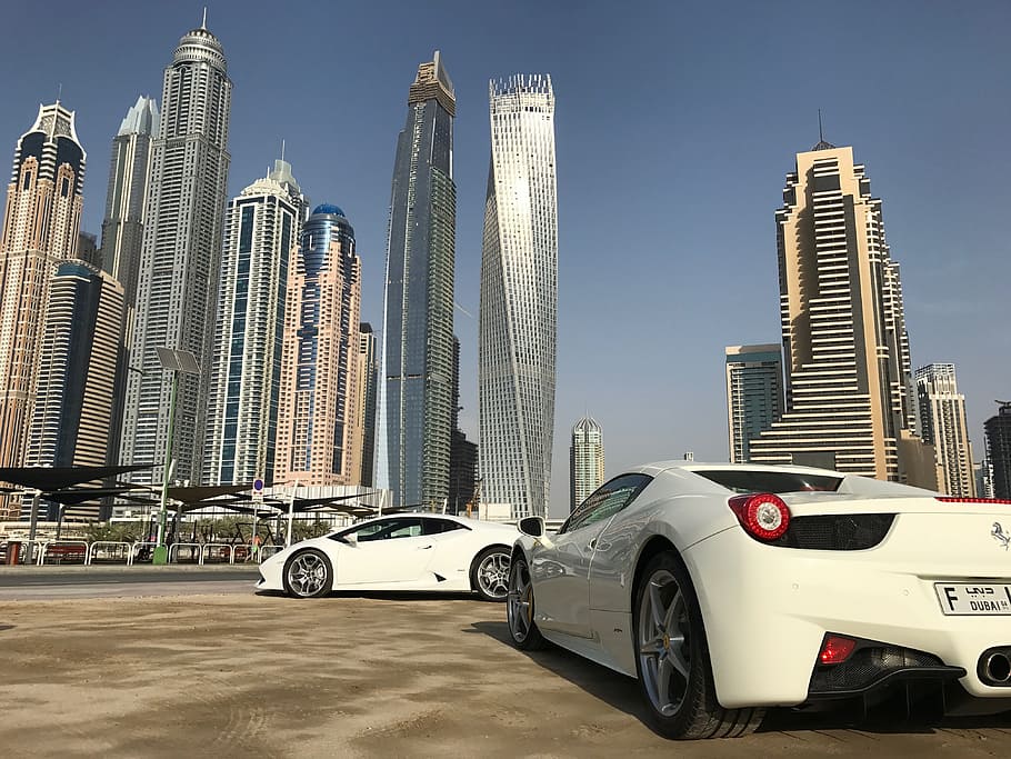 white Ferrari sports car near city buildings during daytime, Dubai Marina