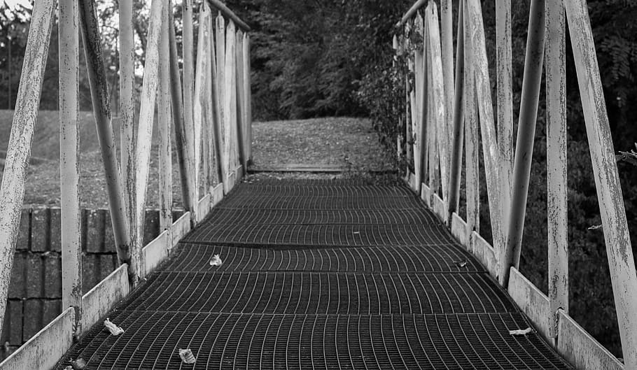 grayscale photo of concrete bridge, path, railing, risk, atmosphere