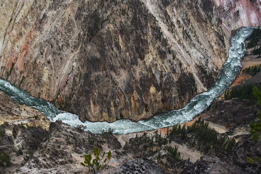 Not a drone photo, aerial photo of body of water between trees and mountain during daytime HD wallpaper