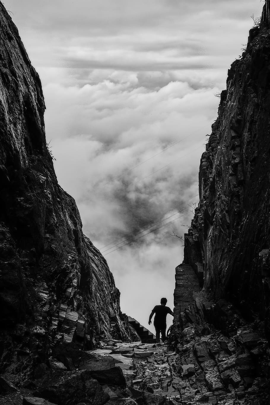 Silhouette of Man Walking Between Two Cliff, adventure, black and white
