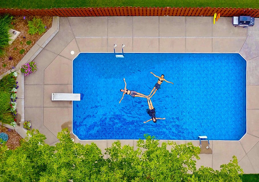 aerial photography of three women floating on pool forming propeller, three women floating link feet in pool at daytime HD wallpaper