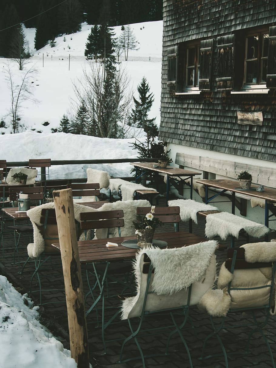 closeup photo of brown table with chair set outside the house, white textiles on brown wooden bench HD wallpaper
