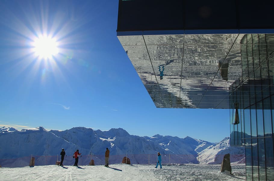 people standing near glass building front of alps, sun, sunbeam HD wallpaper