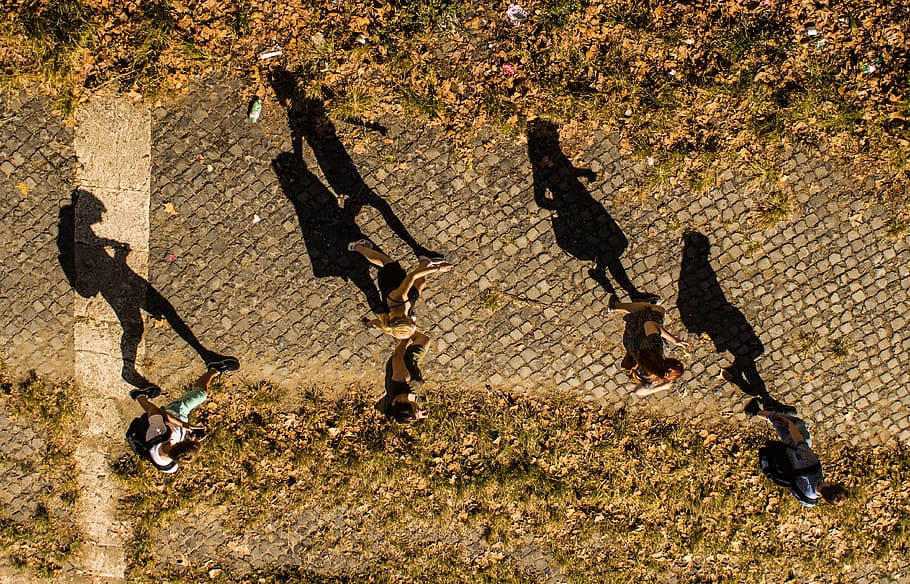 silhouette of person walking in the street, aerial photo of person walking on road during daytime HD wallpaper