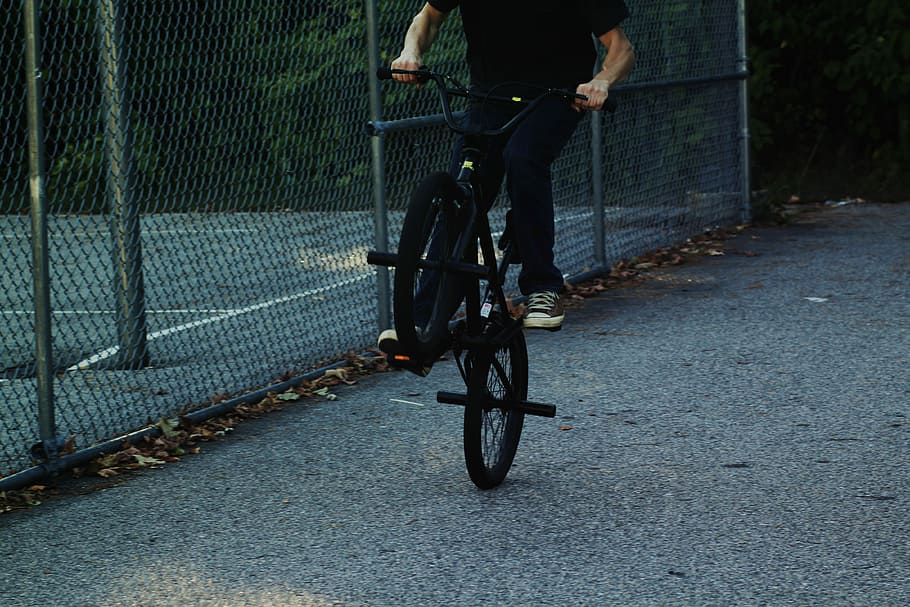 person riding BMX bike near chain link fence, time lapse photography person riding BMX bike, HD wallpaper