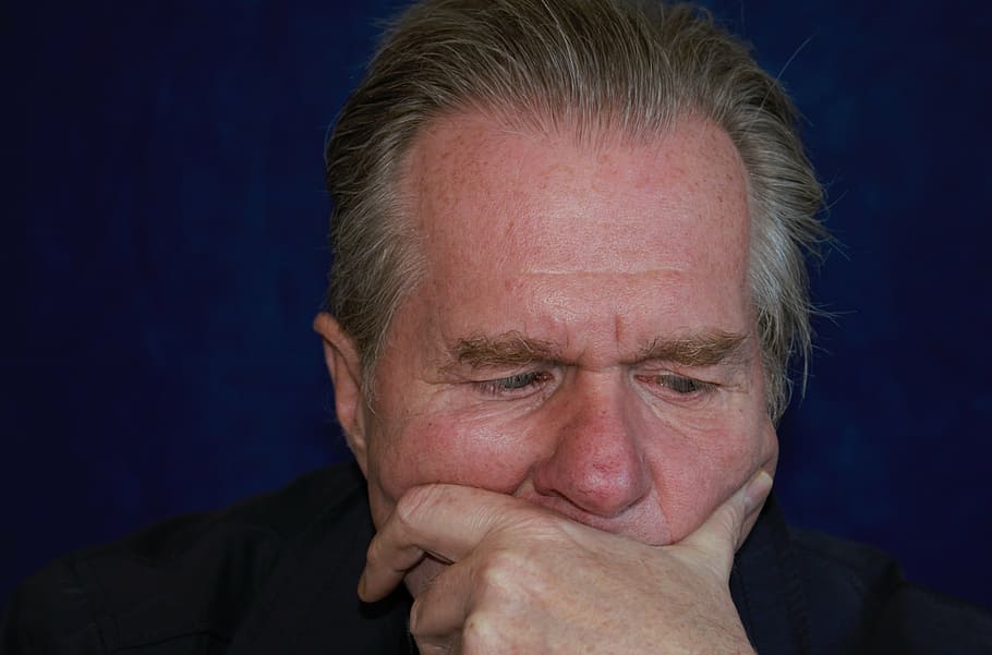 man in black shirt putting his left hand on his face, portrait HD wallpaper
