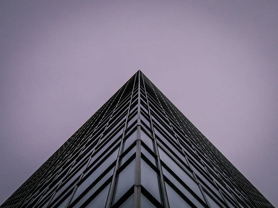 low angle photography of concrete building, low angle photography of curtain glass walled building HD wallpaper