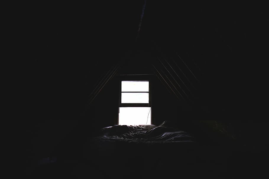 person lying on bed, dim, attic, window, dark, room, light, blanket