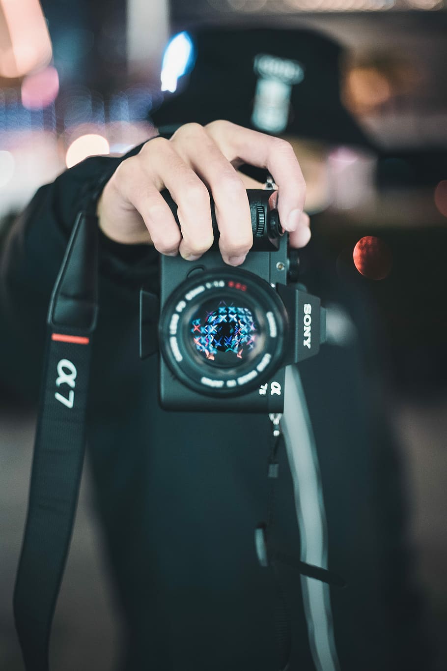 person holding black Sony Alpha DSLR camera, person holding camera HD wallpaper