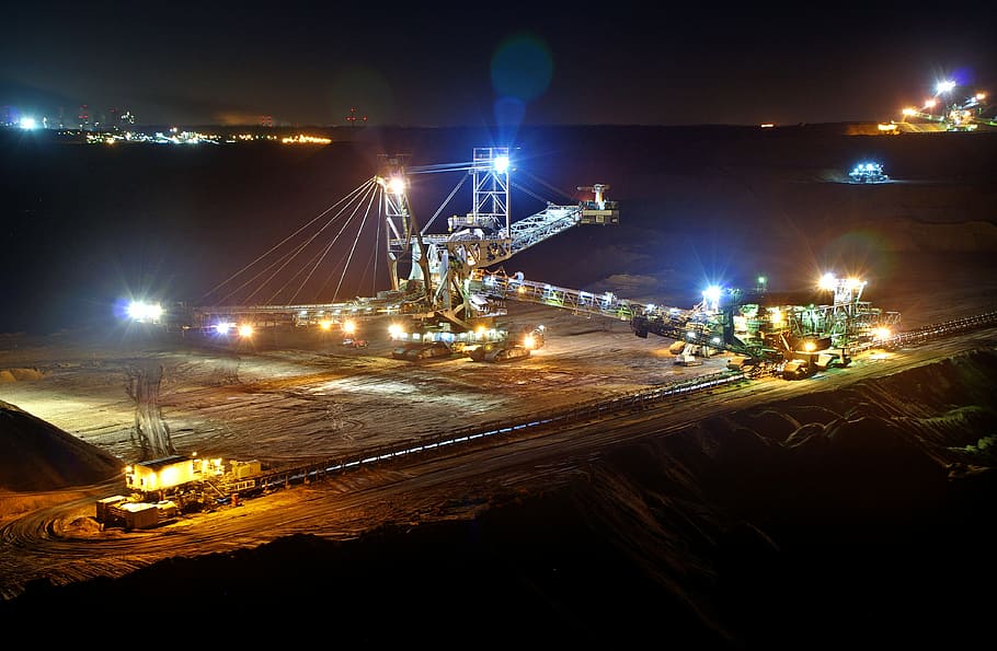 aerial photography of gray crane tower, open pit mining, night