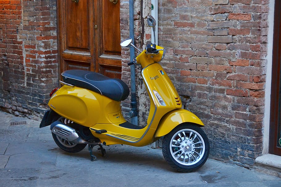 Green scooter sits outside a brick | Free Photo - rawpixel