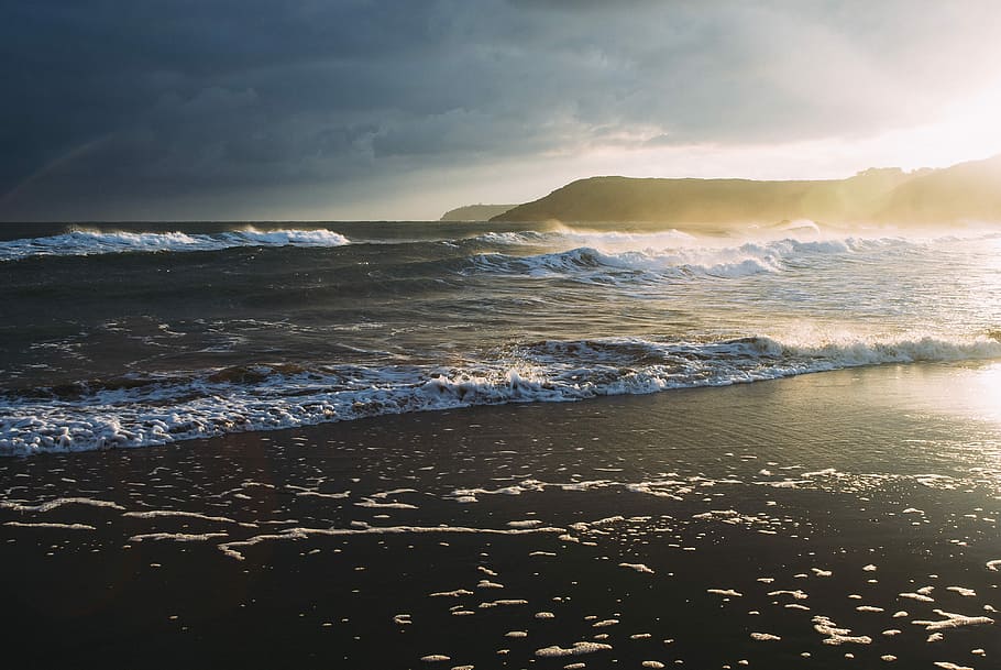 seawaves during sunrise, body of water near mountain, beach, shore HD wallpaper
