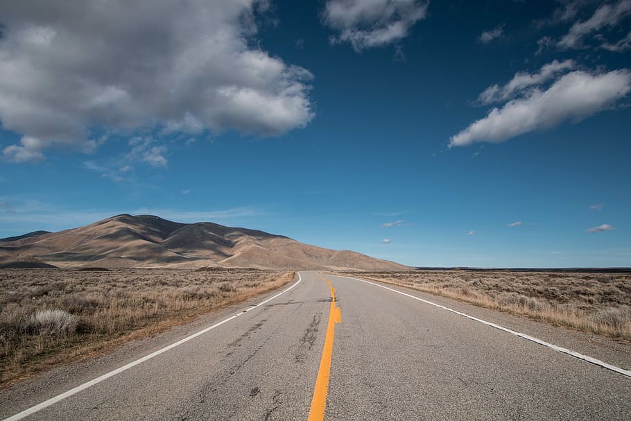 selective focus photo of road under blue sky, landscape photography of road path and mountain HD wallpaper