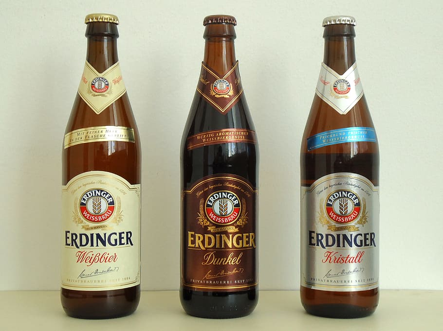 three Erdinger beer bottles on white surface, german, alcohol