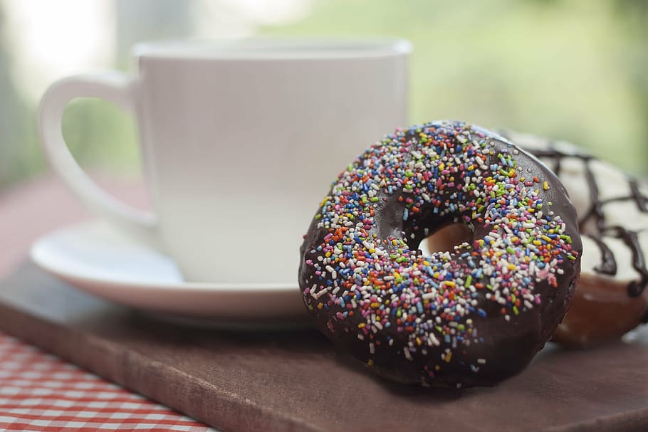 two chocolate daughnuts beside teacup, dona, breakfast, picnic HD wallpaper
