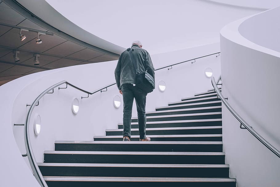 man wearing black jacket standing on black concrete stairs, man standing on stair, HD wallpaper