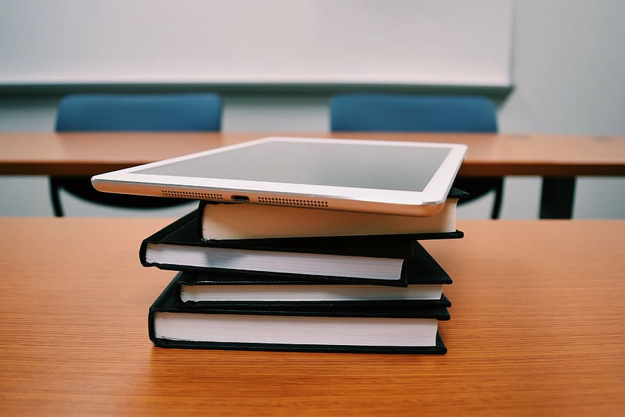 silver iPad on top of four black books, tablet, education, desk HD wallpaper