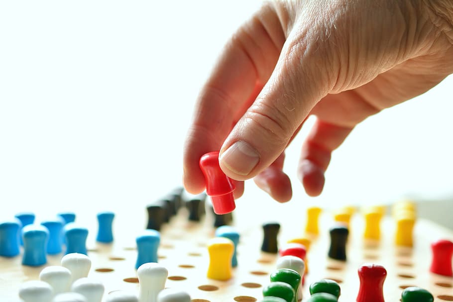 person holding multicolored plastic components, hand, game characters HD wallpaper