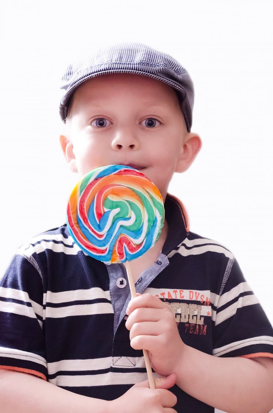 boy wearing black and white striped polo shirt holding lollipop HD wallpaper