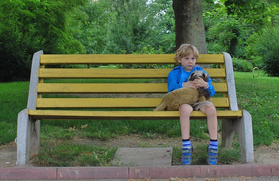 yellow and gray wooden bench, boy, alone, sitting, toy, sad, child
