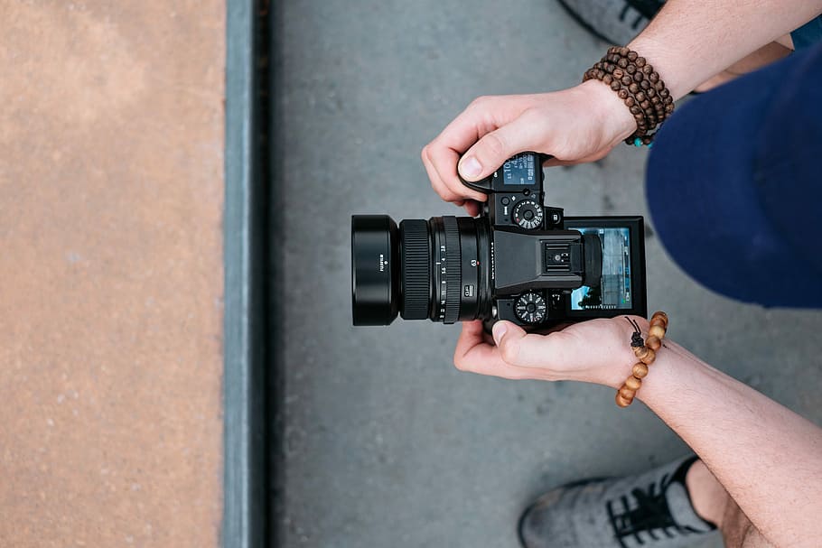 Fujifilm GFX50S medium format camera, person holding camera, dial HD wallpaper