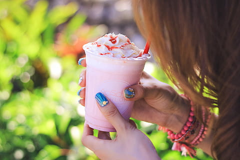 person holding clear plastic cup with pink and white substance HD wallpaper